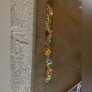 Necklace with hand blown glass flowers .